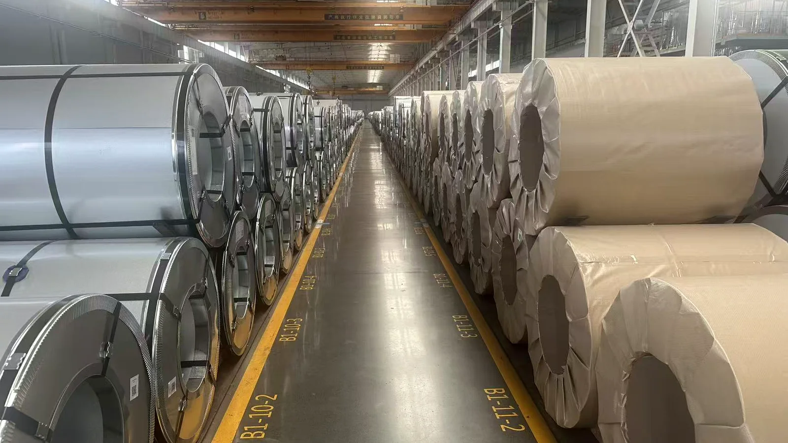 Packed and unpacked steel coils arranged for storage and shipment